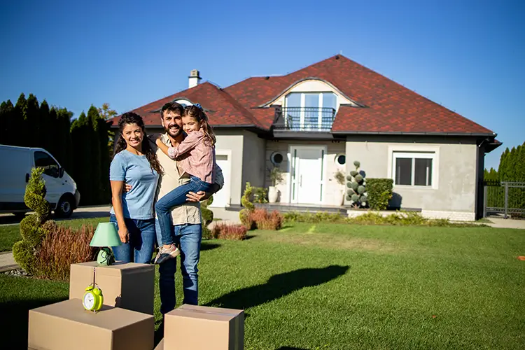 Family in front of their new house